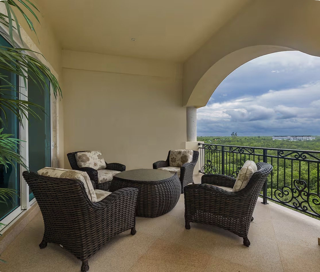 Condo 510 covered balcony with seating overlooking the jungle
