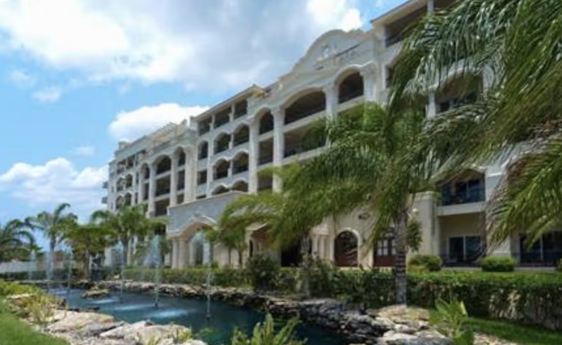 The Landmark Cozumel exterior with palm-lined koi ponds
